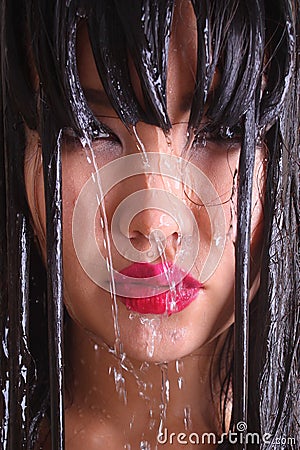 Woman s face with freckles under water jets