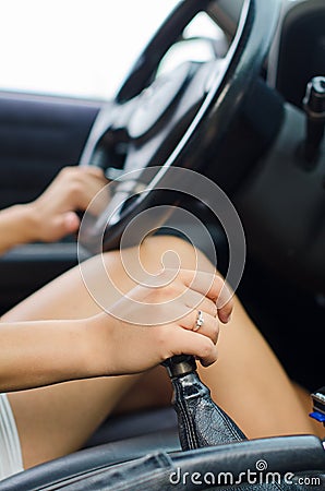 Woman s hand driving a car.