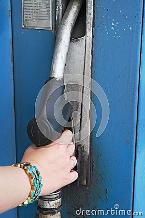 Woman s hand holding fuel nozzle