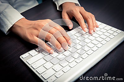 Woman s hand typing on computer keyboard