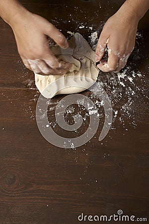 Woman s hands kneading dough
