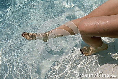 Woman s legs and feet in the water