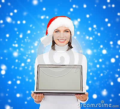 Woman in santa helper hat with laptop computer