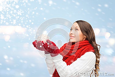 Woman in scarf and mittens with christmas ball