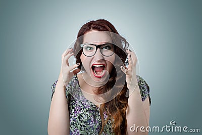 Woman screaming in horror, grimace portrait