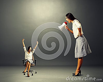 Woman screaming at small woman on the office chair