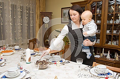 Woman setting table with her child