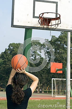 Woman Shooting Basketball at the Ho