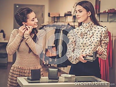 Woman and shop assistant choosing jewellery