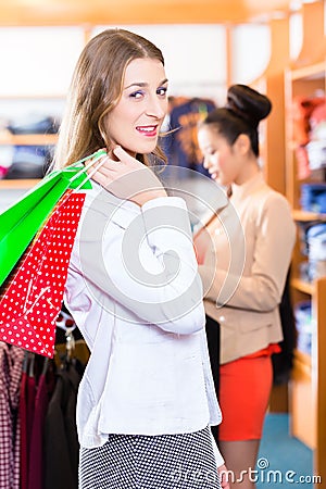 Woman with shopping bags in shop