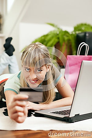 Woman shopping online via Internet from home