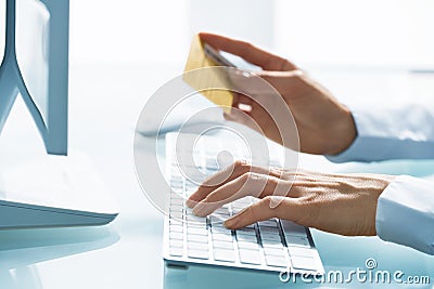 Woman shopping using computer and credit card .indoor.close-up