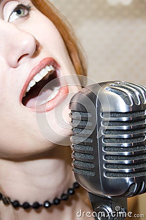 Woman singing into microphone