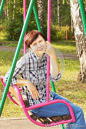 Woman sits on a swing