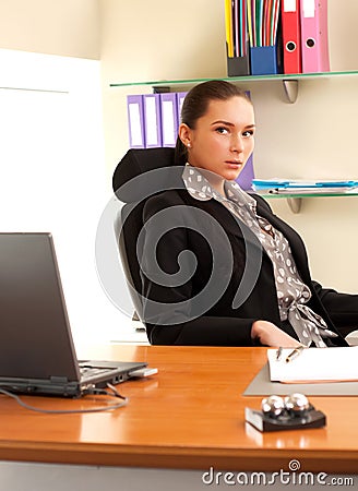 Woman sitting in the office in front of the laptop
