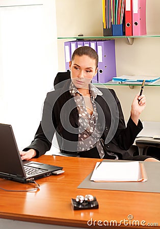 Woman sitting in the office in front of the laptop