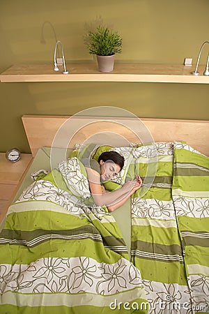 Woman sleeping alone in morning