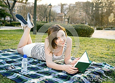 Woman sleeping with a hat over her face in a park