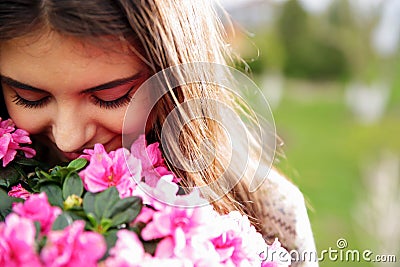 Woman smelling pink flowers