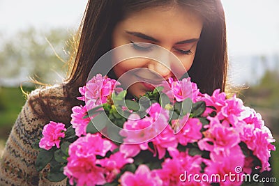 Woman smelling pink flowers