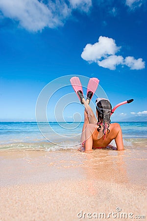 Woman snorkel flippers on beach