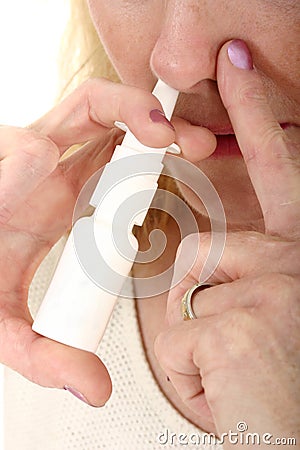 Woman Spraying Nasal Spray 1