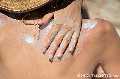 Woman spreading sun tan lotion