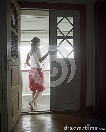 Woman Standing In Open Door