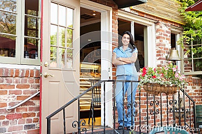 Woman standing outside bakery/cafe