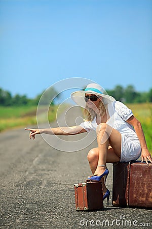 Woman with suitcase stops the car