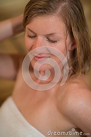 Woman sweating in the sauna