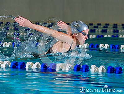 Woman swims using the butterfly stroke