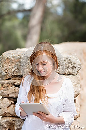 Woman with a tablet-pc in the park