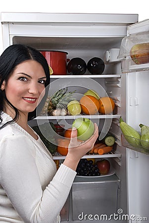 Woman take green apple from fridge