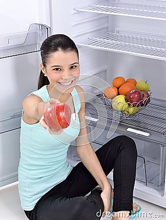 Woman take red apple from fridge