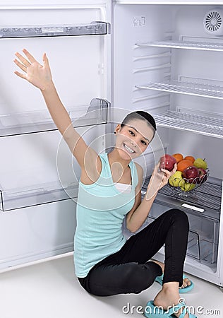 Woman take red apple from fridge