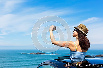 Woman taking selfie photo on car summer travel