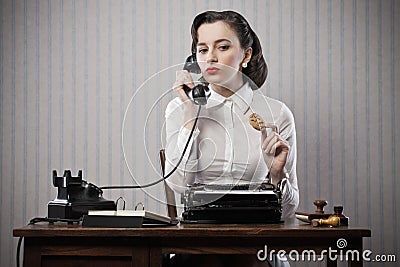 Woman talking on phone at desk