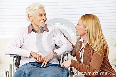 Woman talking to senior citizen