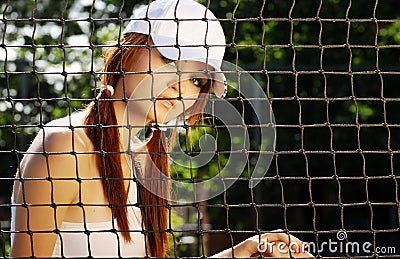 Woman tennis player sitting behind the net