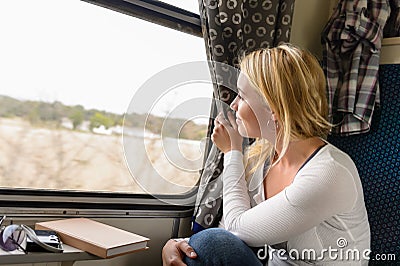 Woman train traveling looking out the window