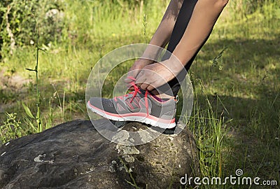 Woman tying her sports shoes