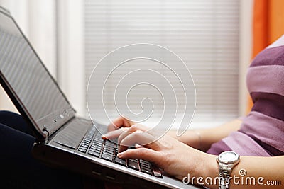 Woman typing on laptop pc, female using computer sitting on the