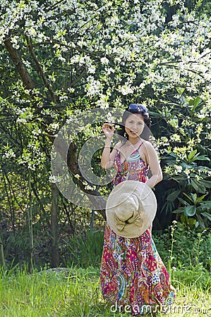 Woman under plum trees