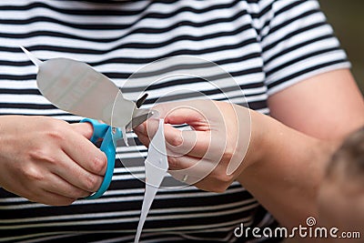 Woman Uses Scissors To Cut Pattern For Child s Art Project