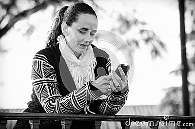 Woman using a mobile phone in black and white