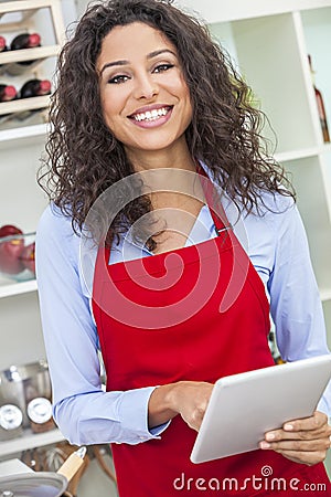 Woman Using Tablet Computer Cooking in Kitchen