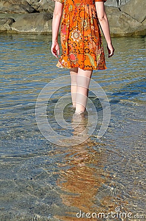 Woman wading through sea water