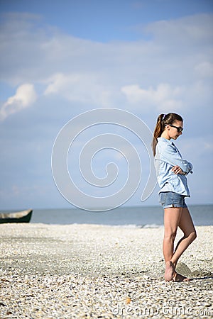 Woman walking away on the beach