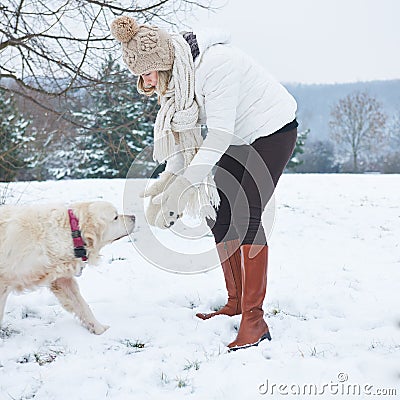 Woman walking the dog in winter